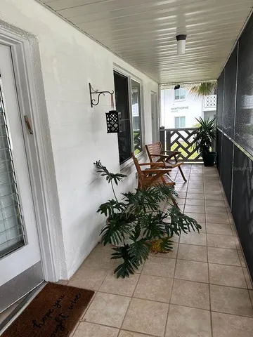 a hallway with table and chairs