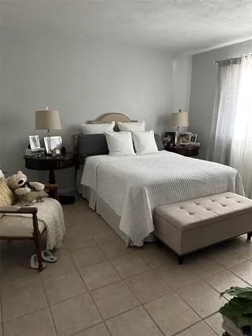 a bedroom with bed and a window