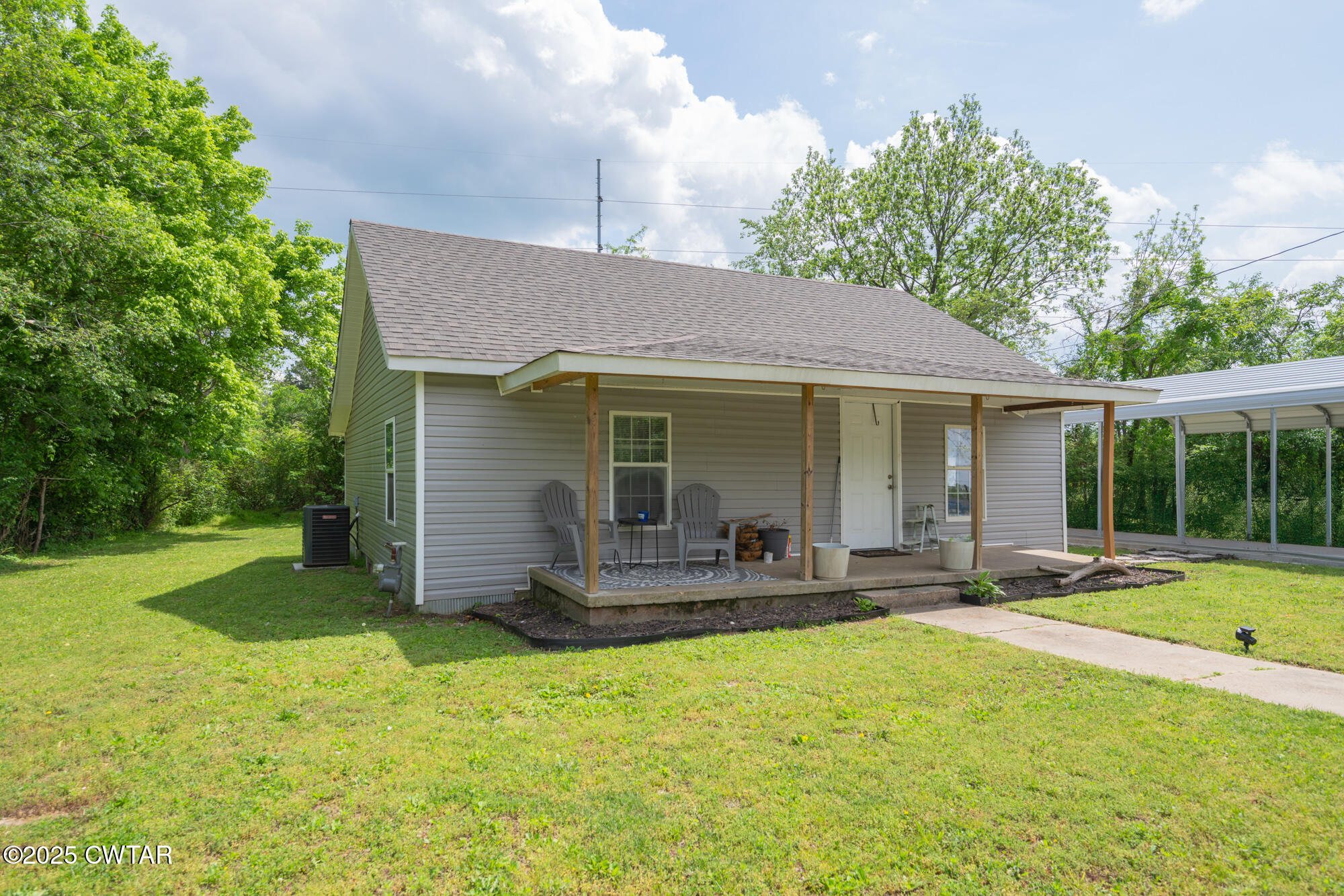 a front view of a house with a garden and patio