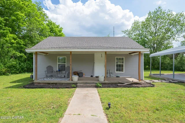 a front view of house with a garden and patio