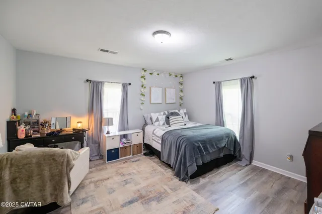 a spacious bedroom with a bed and a couch