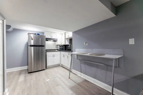a kitchen with a sink cabinets and stainless steel appliances