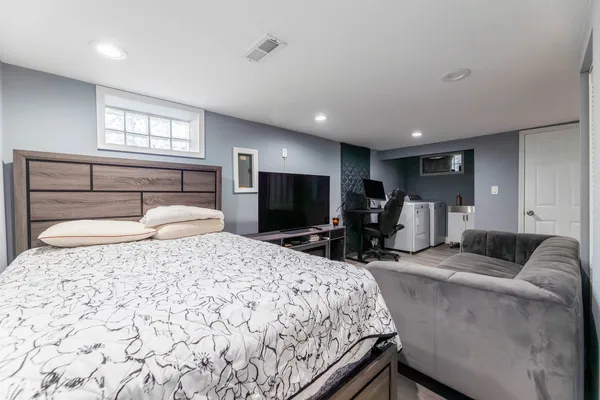 a bedroom with a bed and glass windows