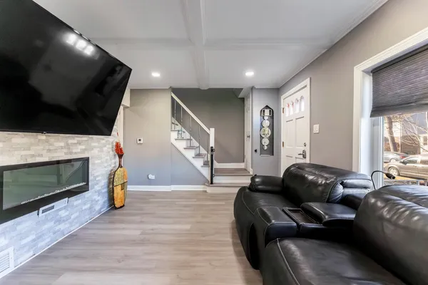 a living room with furniture a flat screen tv and a fireplace