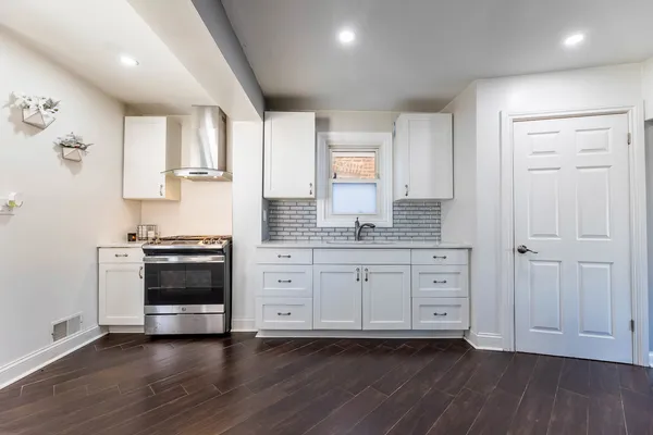 a kitchen with stainless steel appliances granite countertop a stove and a sink