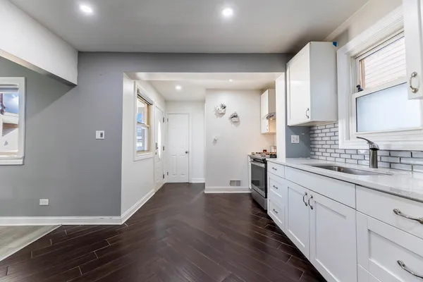 a view of a kitchen with electric appliances