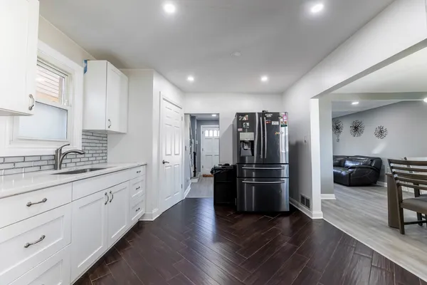 a kitchen with stainless steel appliances kitchen island granite countertop a refrigerator and a stove