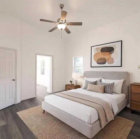 a bedroom with a bed and a painting on the wall