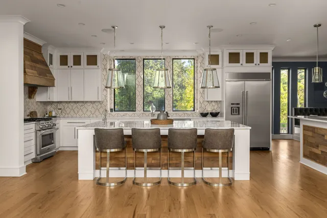 a kitchen with a sink cabinets and wooden floor
