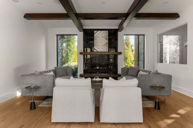 a work room with furniture and large windows