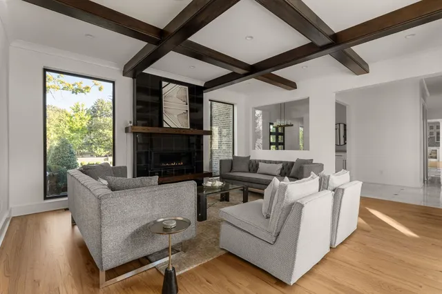 a view of dining room with wooden floor and floor to ceiling window