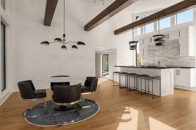 a view of a brick house with a small yard and wooden fence