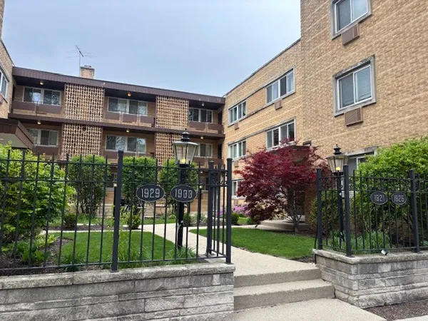 a view of a brick building next to a yard