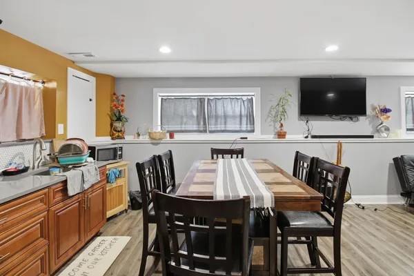 a view of a dining room with furniture and a flat screen tv