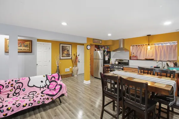 a living room with furniture a flat screen tv and kitchen view