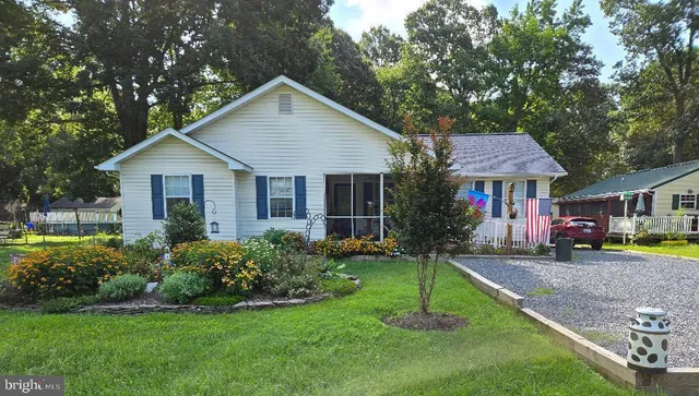 a front view of a house with a yard and porch