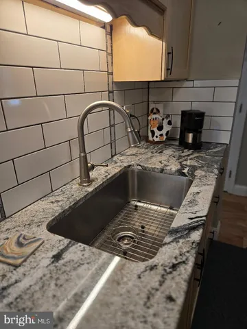 a kitchen with stainless steel appliances granite countertop a stove a refrigerator and a microwave