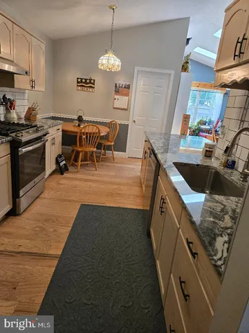 a view of a dining room with furniture and a chandelier