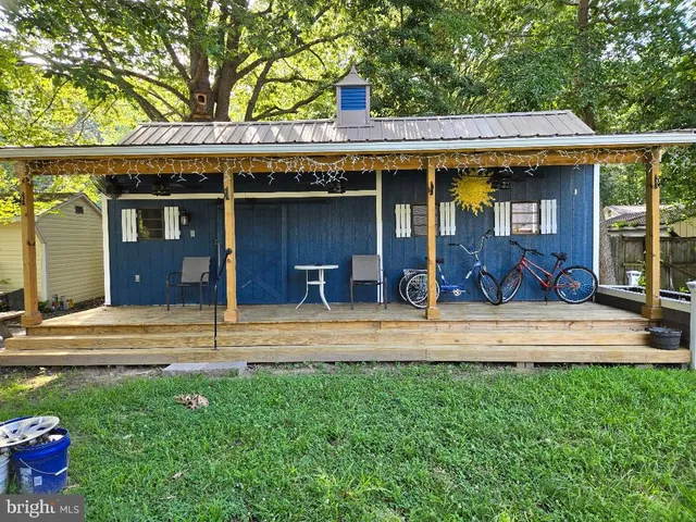 a view of a house with a yard and potted plants