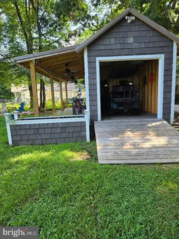 a view of a house with a backyard and porch