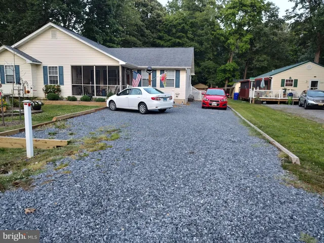 a garden with a lot of flower plants in front of main door