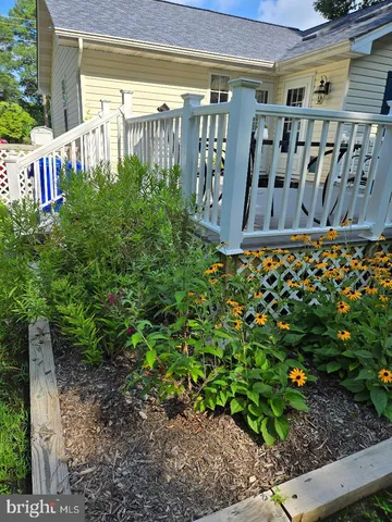 a view of a house with backyard sitting area and garden