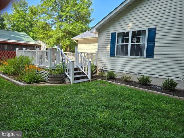 a view of a town with barn and large trees