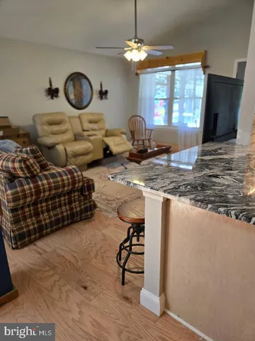 a living room with a flat screen tv and a stove