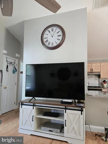 a living room with furniture a rug and a chandelier