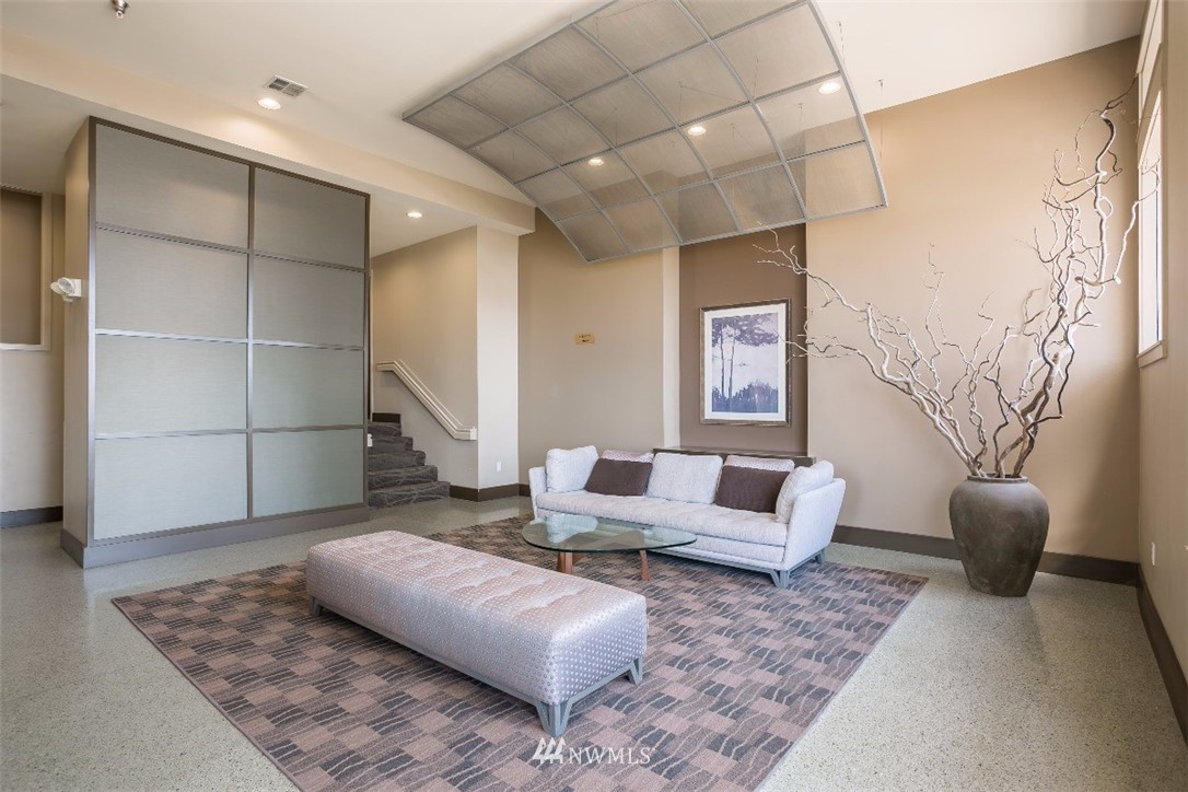 2000 Alaskan Way, Unit 257 Seattle, WA 98121 - Photo 2 of 25 a living room with furniture and a rug