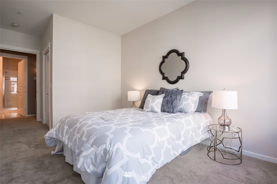 2000 Alaskan Way, Unit 257 Seattle, WA 98121 - Photo 14 of 25 a bedroom with bed and a window