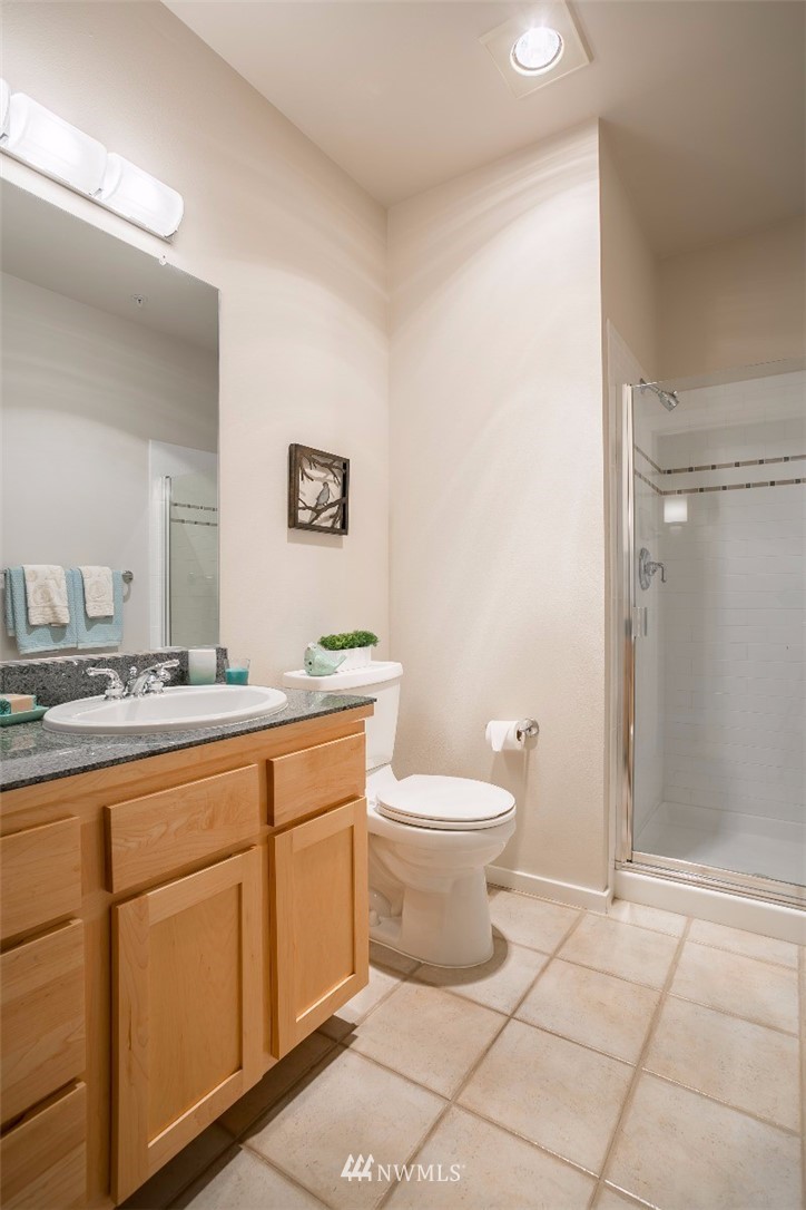 2000 Alaskan Way, Unit 257 Seattle, WA 98121 - Photo 15 of 25 a bathroom with a toilet sink and mirror