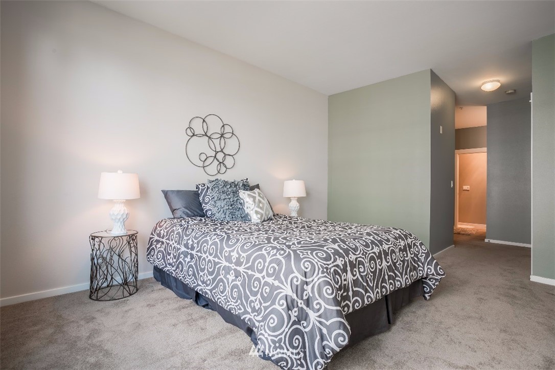 2000 Alaskan Way, Unit 257 Seattle, WA 98121 - Photo 17 of 25 a bedroom with a bed and a table