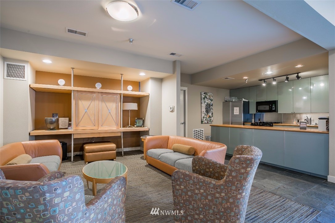 2000 Alaskan Way, Unit 257 Seattle, WA 98121 - Photo 20 of 25 a living room with furniture and a table