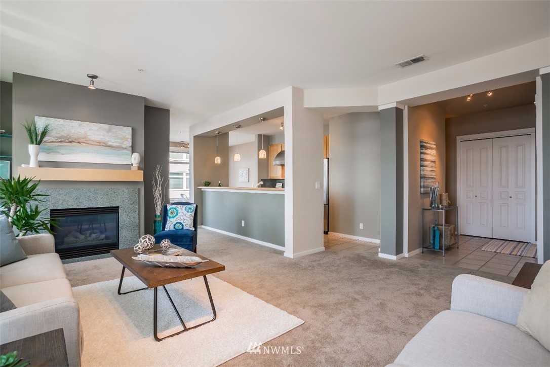 2000 Alaskan Way, Unit 257 Seattle, WA 98121 - Photo 7 of 25 a living room with furniture and a fireplace