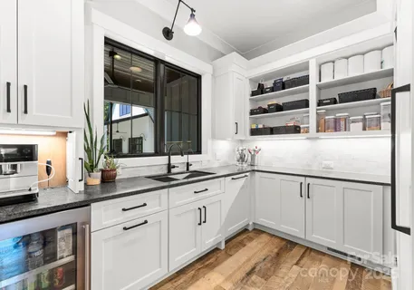 a kitchen with stainless steel appliances granite countertop a sink and cabinets