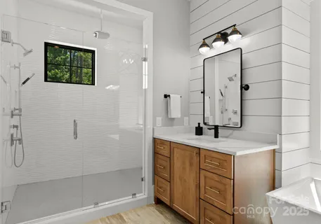 a bathroom with a granite countertop sink a mirror and shower