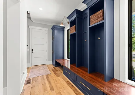 a view of a hallway with wooden floor and closet