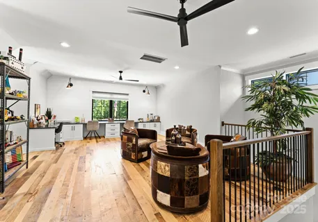 a living room with furniture a couch and a potted plant