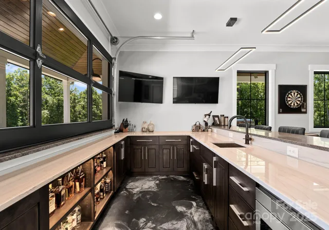 a large kitchen with stainless steel appliances granite countertop a sink and a stove