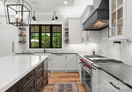 a kitchen that has a sink and a stove