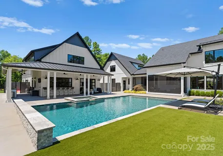 swimming pool view with a seating space and garden view
