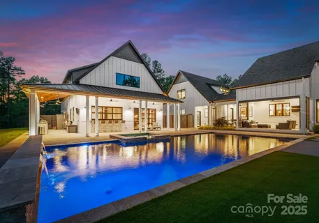 a view of an house with swimming pool yard and outdoor seating