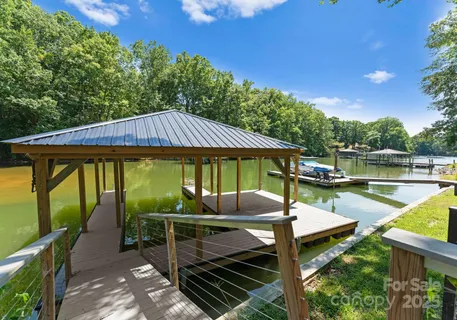 a patio with glass top table and chairs