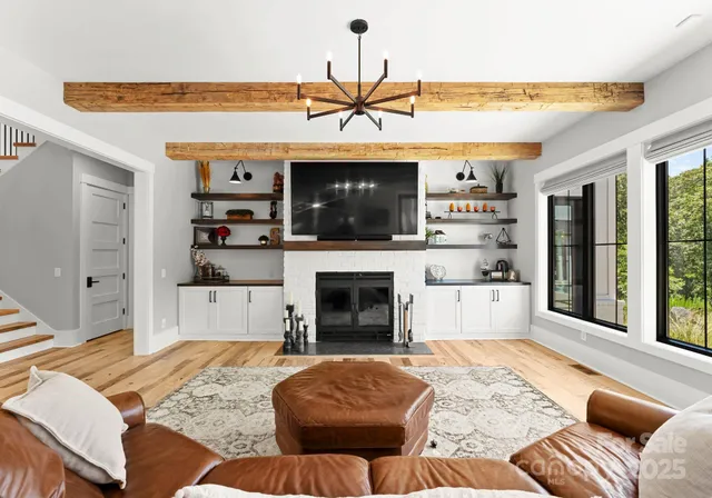 a living room with fireplace furniture and a flat screen tv