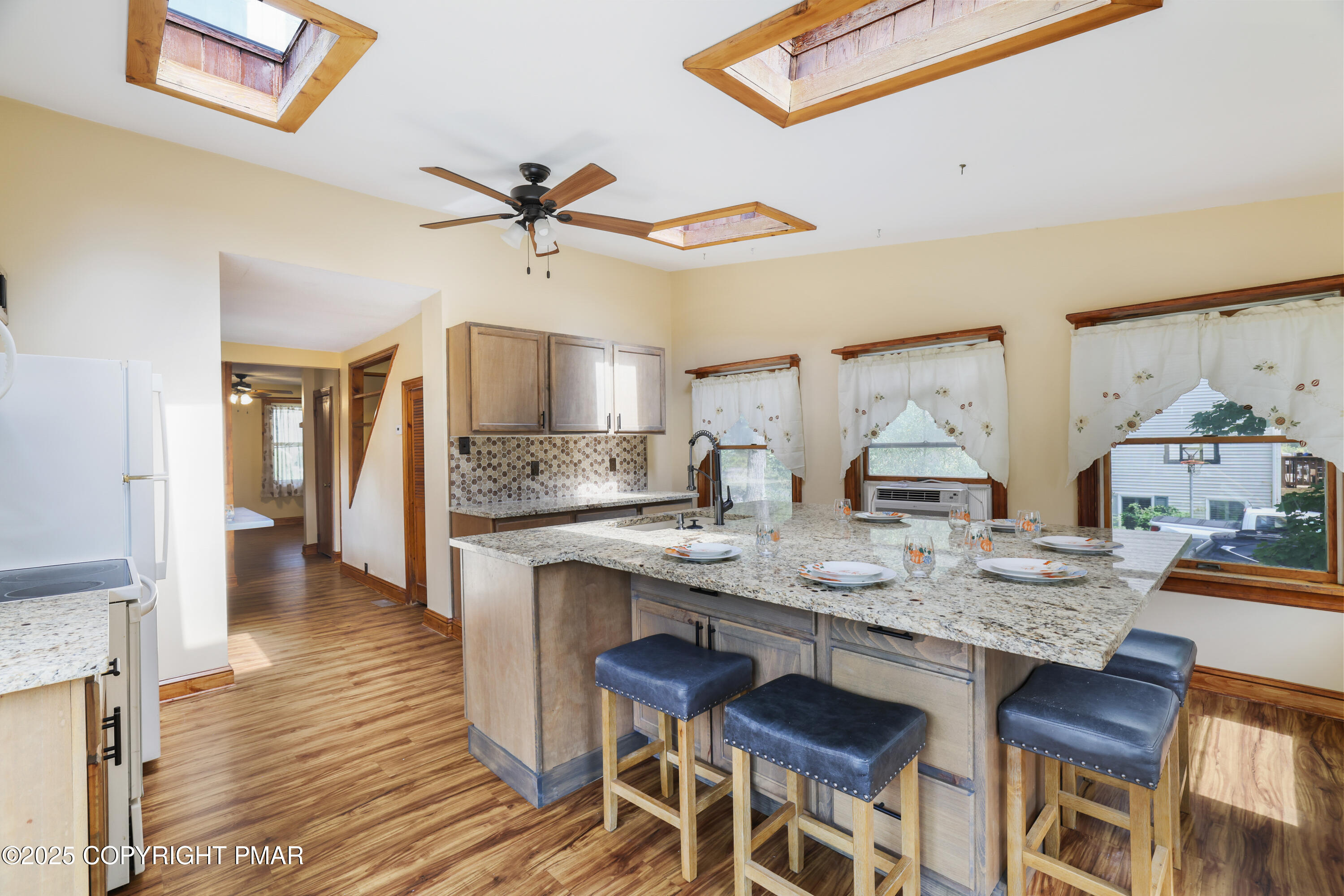 29 Reeder Street Mount Pocono, PA 18344 - Photo 26 of 50 a open kitchen with granite countertop a table and chairs in it