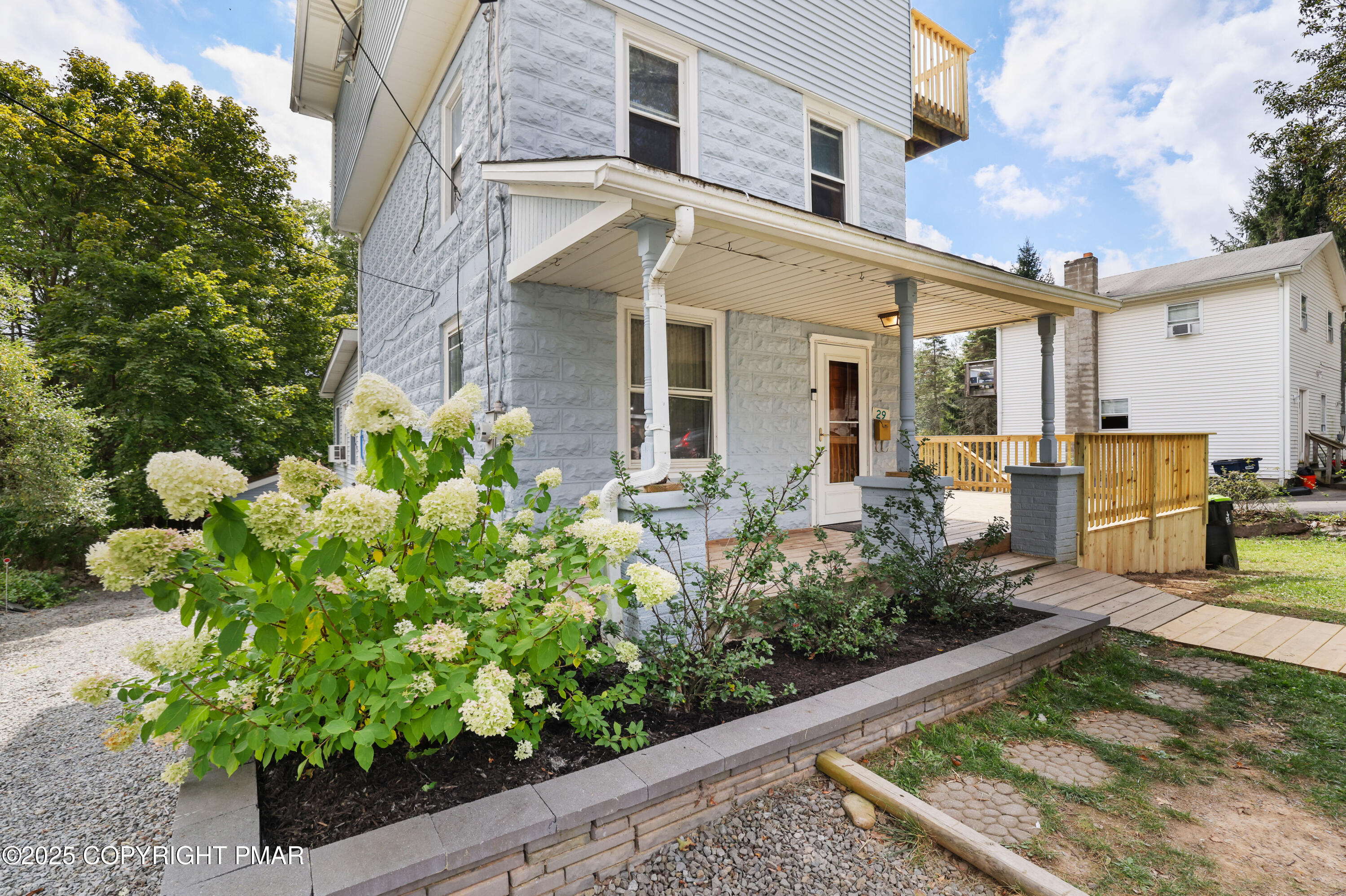 29 Reeder Street Mount Pocono, PA 18344 - Photo 3 of 50 a front view of a house with lots of flowers around