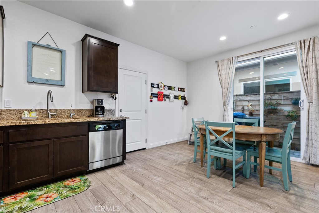 9354 Riberena Circle Atascadero, CA 93422 - Photo 10 of 47 a kitchen with granite countertop a dining table chairs sink and wooden floor