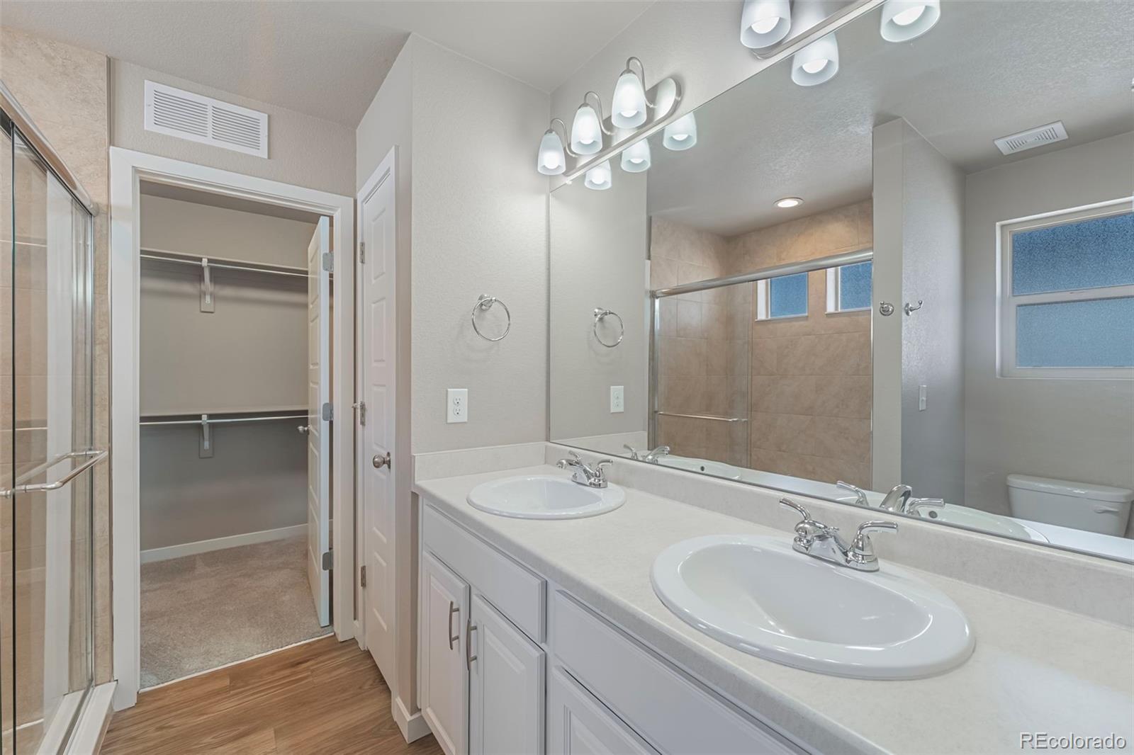 9528 Timberlake Loop Colorado Springs, CO 80927 - Photo 20 of 37 a bathroom with a double vanity sink and a mirror