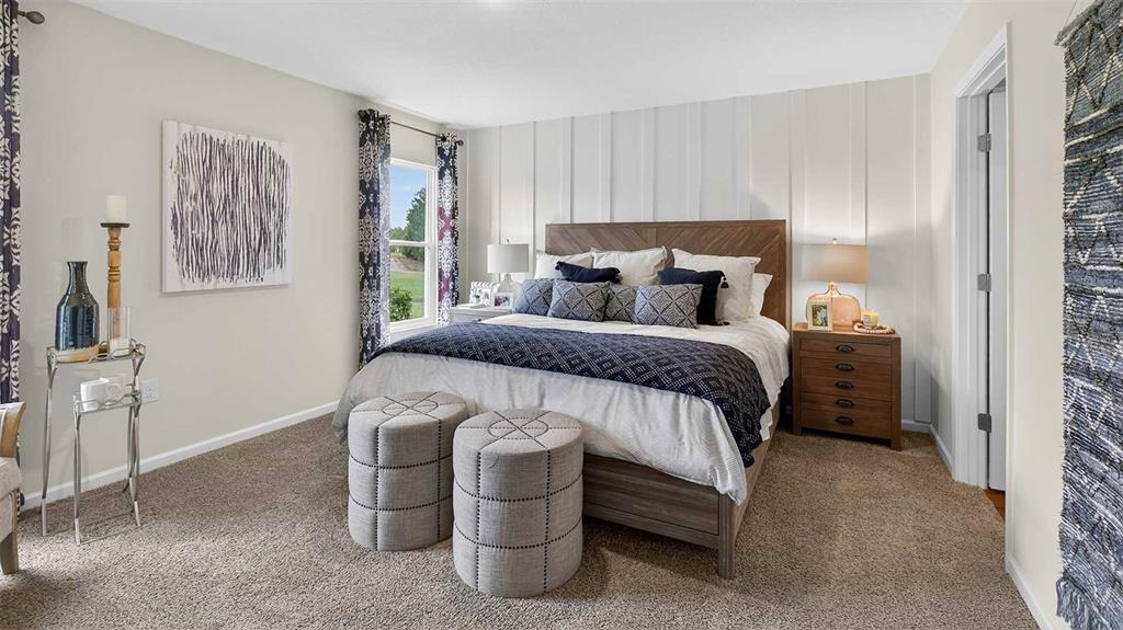 34 Divot Place Bunnell, FL 32110 - Photo 14 of 51 a bedroom with a bed and a table in it